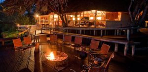 Beautiful fire pit surrounded by chairs at Savuti Camp